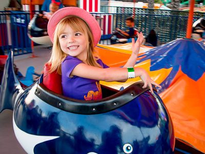 Girl smiling on Bulgy seaside park ride