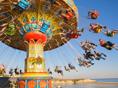 People on Sea Swings seaside park ride