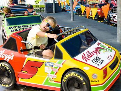 Kids riding Speedway seaside park ride