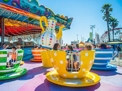 People having fun on Twirlin' Teacups seaside park ride