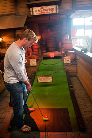Man playing mini golf